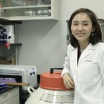 Jiyeon Kim in a lab wearing white coat.