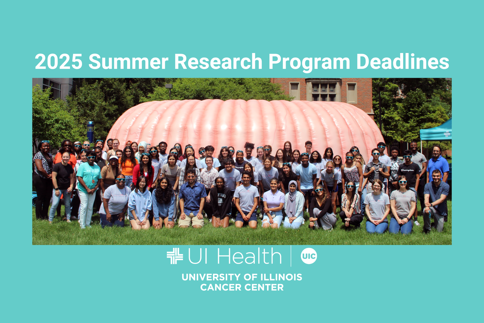 Image of students in summer cancer research programs at the University of Illinois Cancer Center posing in front of CECIL, the Cancer Center's giant inflatable colon.